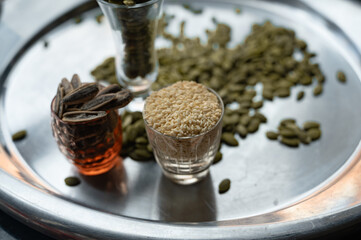 Still life with sunflower, sesame, and pumpkin seeds in glass cups
