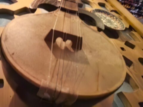 Craftsmanship of a traditional string instrument displayed on a wooden surface