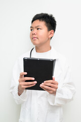 Young Asian Boy Dressed as Doctor with Stethoscope Using Digital Tablet Computer