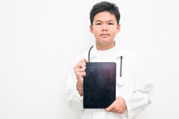 Young Asian Boy Dressed as Doctor with Stethoscope Using Digital Tablet Computer
