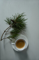 Morning cup of coffee and decor Christmas green tree with a pine cone. Ornament holiday background,...