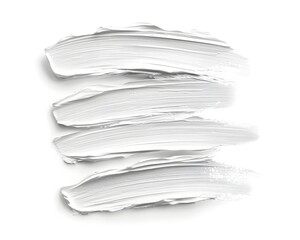 Four thick, textured streaks of opaque white material are displayed horizontally on a bright surface.