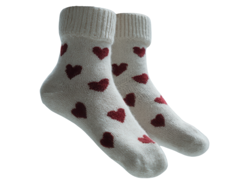 Legs with white socks covered in red hearts.