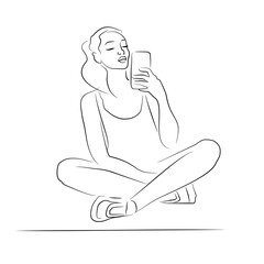 A young woman takes a selfie while sitting on a yoga mat. Relaxation. The female silhouette is drawn with a brush. Sitting pose.