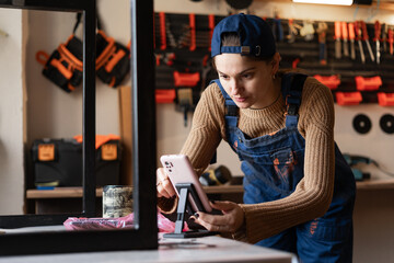 diy blogger repairwoman or handywoman recording video of hobby in craft workshop.