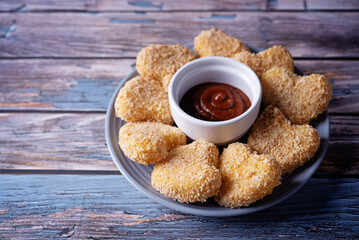 Potato croquette in the form of hearts with ketchup sauce for Valentine's day holidays