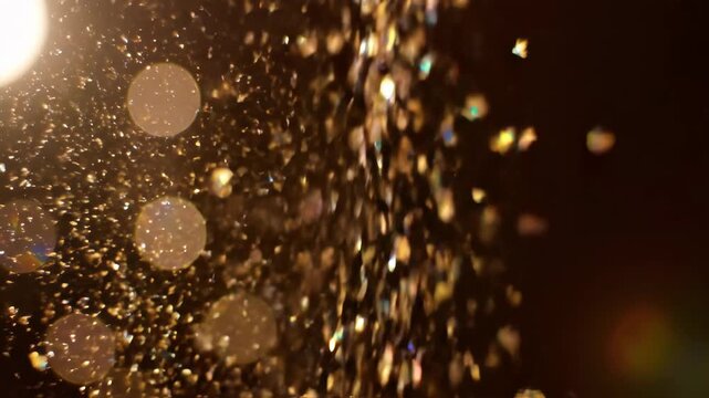 Sparkling golden light effect, bokeh, with blurred particles and circles. A glowing, dark background