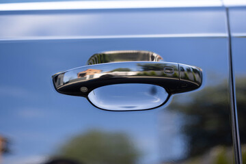 Keyless entry car door handle with keyless go touch sensor. Automatic opening of a car door without a key. Car door handle. Access button. Exterior design of a new electric hybrid luxury car