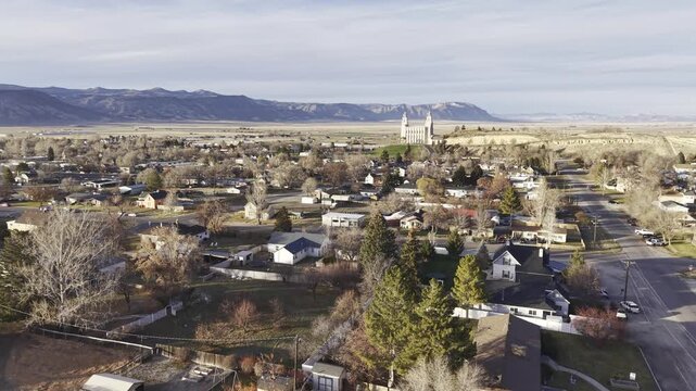 Drone flying over a small town in the Rocky Mountains near a Mormon Temple