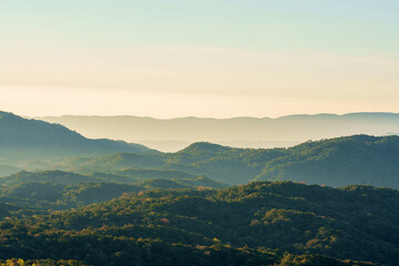 Beautiful sunrise glow over the green mountain ranges in Northern Thailand.