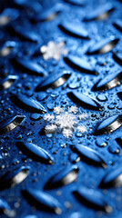 Snowflake cluster on wet blue metal plate with water droplets, macro winter texture and icy detail creating crisp cold mood