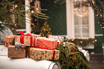 Christmas gift package on car roof. Holiday snow day and winter atmosphere.