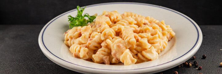 Carbonara pasta fusilli creamy sauce main course Italian cuisine tasty snack fresh delicious gourmet food background on table rustic food top view copy space