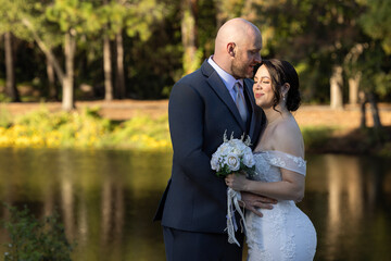 A heartfelt and elegant wedding portrait featuring a beautiful couple (bride and groom) celebrating...