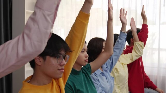 Group of interviewee candidate in colorful casual wearing line up for vacancy interview sitting on the chair. Intern raise hand. Job opportunity recruitment for HR agency and vacancy concept. Synergic