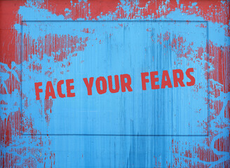 Inscription on a spot of blue paint: face your fears