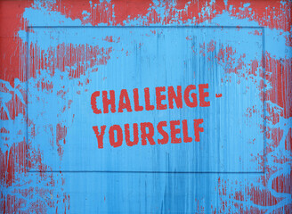 Inscription on a spot of blue paint: challenge yourself
