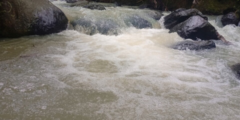 Turbulent Whitewater River Flowing Over Rocks