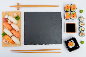 Overhead view of sushi platter with chopsticks and soy sauce