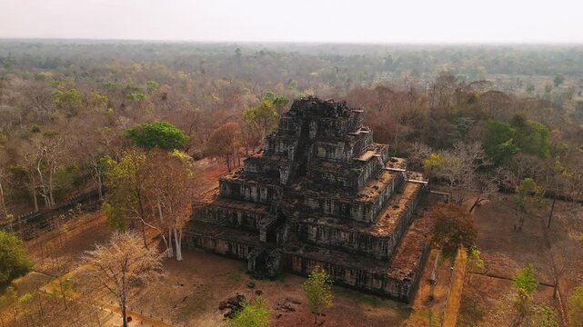 Aerial view of the ancient koh ker pyramid, an archaeological site in the cambodian jungle, showcasing its unique stepped design.
