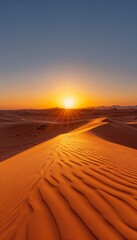 Golden sunset over minimalistic desert landscape with sand dunes and clear blue sky