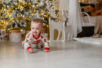A one-year-old baby crawls on all fours, dressed in a New Year's outfit, crawling around a New Year's-decorated room, smiling. New Year and Christmas. Parenting. Family
