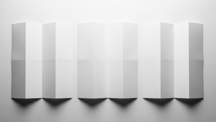 Three white folded paper sheets arranged in a row casting soft shadows on a light surface, abstract minimalist composition with geometric shape and texture