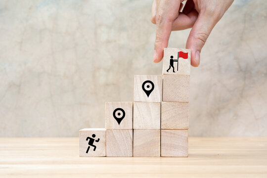 Career Path and Development Strategy Concept. Arranging wooden blocks with icons success roadmap and journey, symbolizing a structured career path and strategic development. Planning, growth, progress
