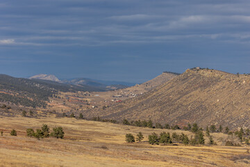 Obraz premium Small clutter of homes in lyons colorado surrounded by a storm brewing along the horizon
