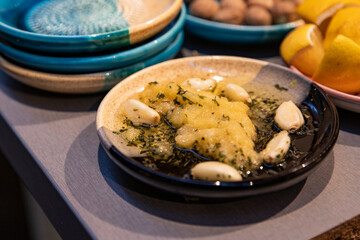 The process of making a garlic sauce using a traditional Spanish ceramic plate
