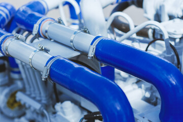 Close-up of bright blue silicone coolant or air intake hoses connected to grey piping using durable...