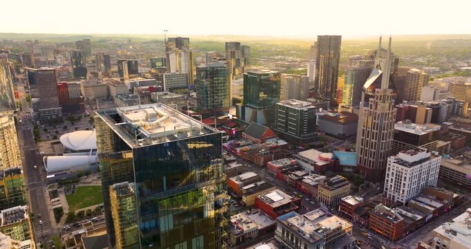 Aerial panorama of downtown Nashville, Tennessee at sunset with modern skyscrapers in developing city.