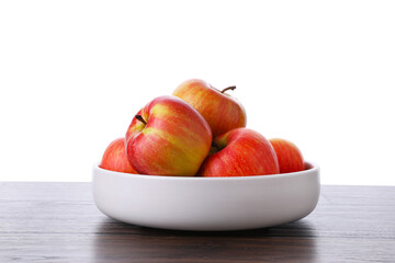 Ripe red apples in bowl on wooden table against white background, closeup