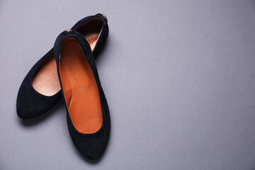Pair of stylish black shoes on grey background, top view. Space for text
