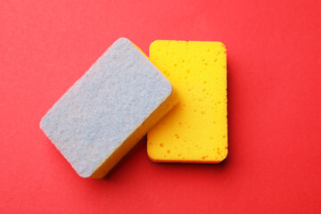 Kitchen sponges on red background, top view