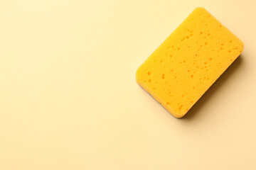Kitchen sponge on beige background, top view. Space for text
