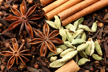 Mulled wine spices. Anise stars, cinnamon sticks, cardamon seeds and cloves as background, top view