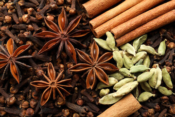 Mulled wine spices. Anise stars, cinnamon sticks, cardamon seeds and cloves as background, top view