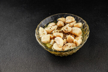 Garlic slices in flavored oil roasted garlic slice in oil fast food natural tasty appetizer fresh delicious gourmet food background on the table rustic top view copy space vegetarian or vegan food