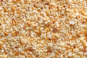 Rustic breadcrumbs on a white background, ideal for creating crunchy, homemade-style coatings and textured culinary preparations.