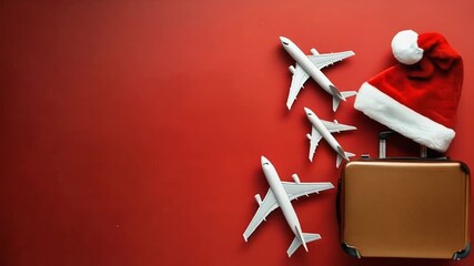 Christmas Travel Concept with Suitcase Planes and Santa Hat.