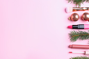 Christmas composition with cosmetic products and fir branches on pink background, flat lay. Space for text