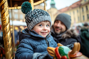 Obraz premium Happy Child Riding Carousel at Christmas Market
