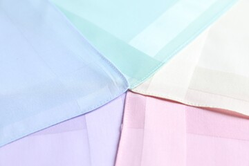 Different pastel color handkerchiefs as background, closeup