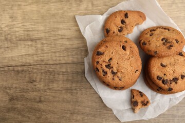 Delicious chocolate chip cookies on wooden table, top view. Space for text