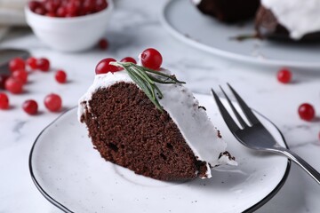 Tasty Christmas cake with cranberries and rosemary served on table, closeup