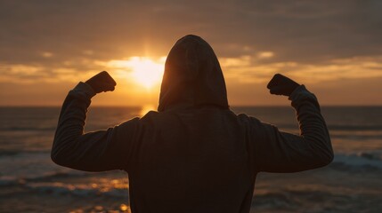 Motivational Silhouette by the Sea at Sunrise with Flexed Arms