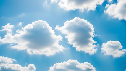 Fototapeta premium Fluffy white clouds drifting across a vibrant blue sky.