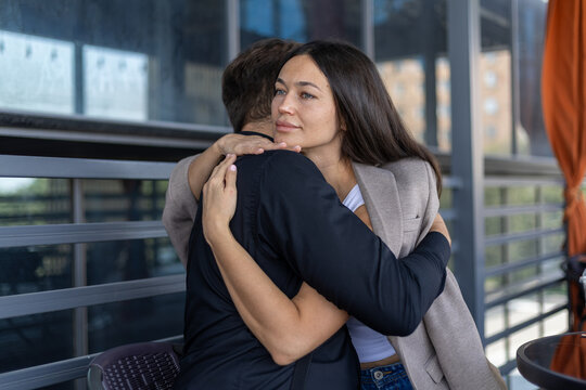 Young woman warmly embracing her upset male partner in a moment of support