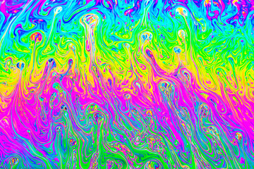 A mesmerizing close-up of a vibrant soap bubble showcasing a kaleidoscope of swirling colors caused by surface light interference.